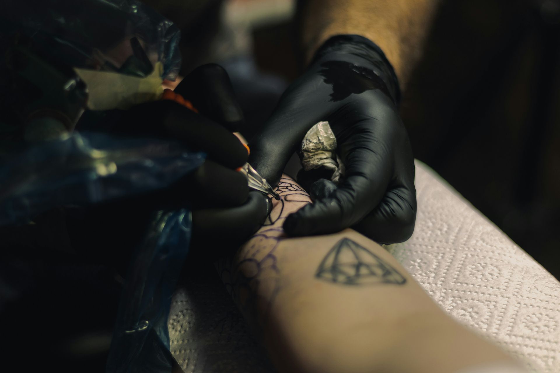 a person getting a tattoo on their arm